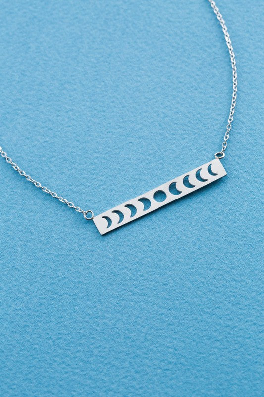Lunar Phase Bar Necklace with an 18K gold over stainless steel bar pendant on a white background.