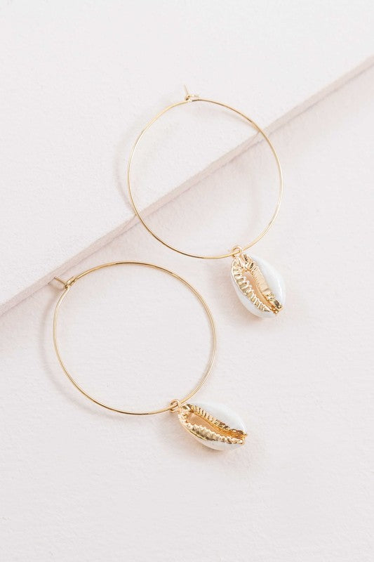 By the Shore Hoop Earrings - 14K hoop earrings with sea shell charm on a white background.