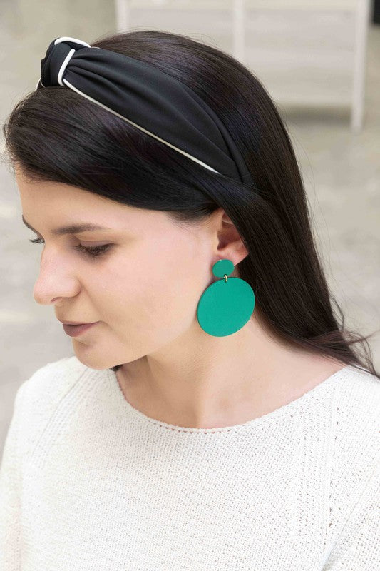 A pair of En Vogue Dangle Earrings in teal color against a white background.