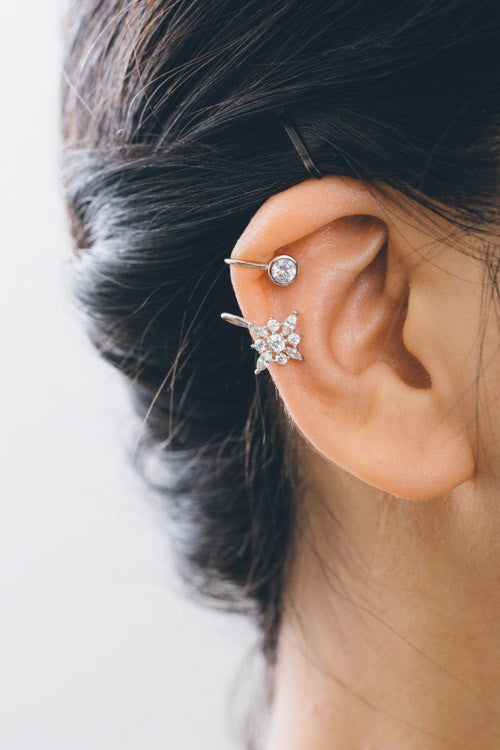 An open First Star Ear Cuff with a star-shaped cluster and a single round gemstone on a white background.