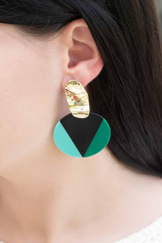 A pair of Color Block Drop Earrings with gold-tone hardware and geometric black and teal design.