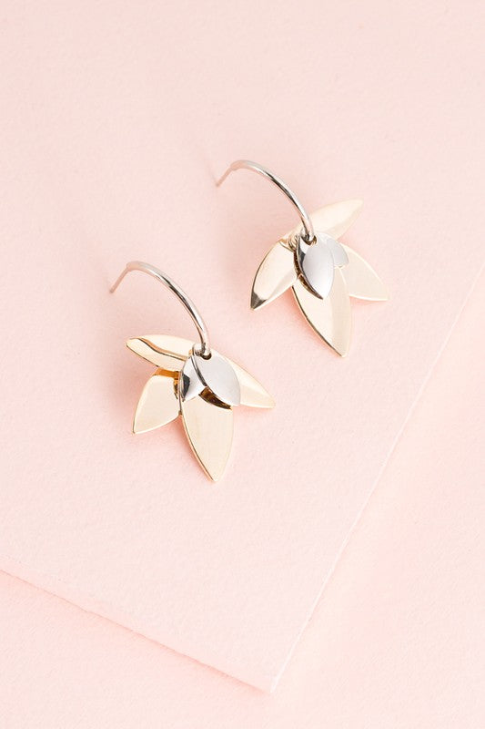 A pair of Two-Tone Lotus Hoop Earrings on a pale pink background.