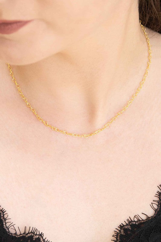 A delicate Chain of Hearts Necklace in 18K Gold over Sterling Silver on a white surface.
