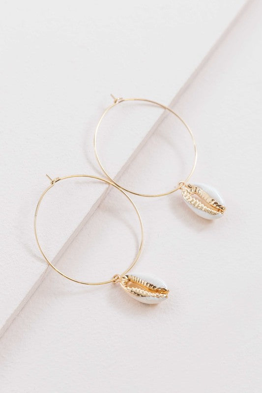 By the Shore Hoop Earrings - 14K hoop earrings with sea shell charm on a white background.