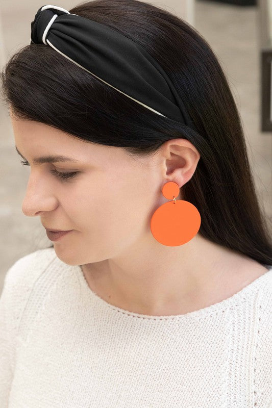 A pair of En Vogue Dangle Earrings in teal color against a white background.