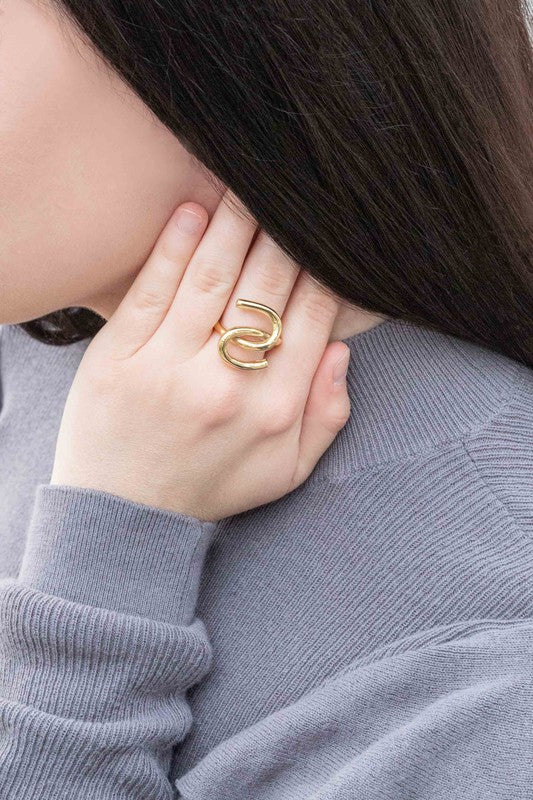 14k gold Tie and Knot Ring presented on a white surface.