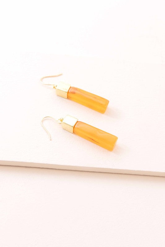 Pair of Dynasty Dangle Hook Earrings on a light background.