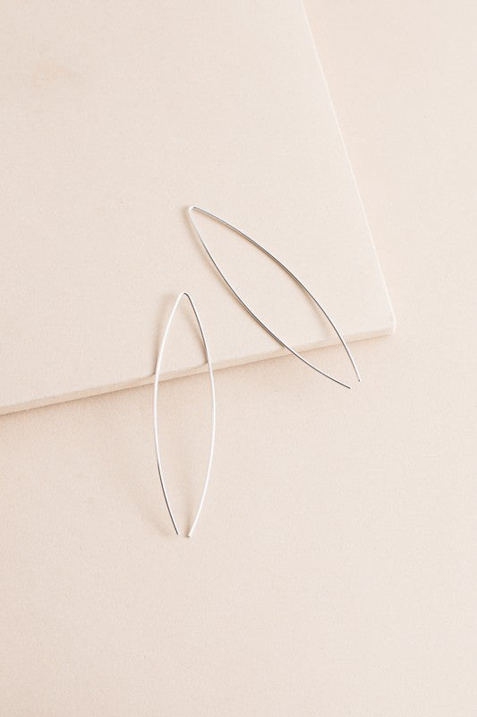 Pair of delicate Arc Threader Earrings on a white background.