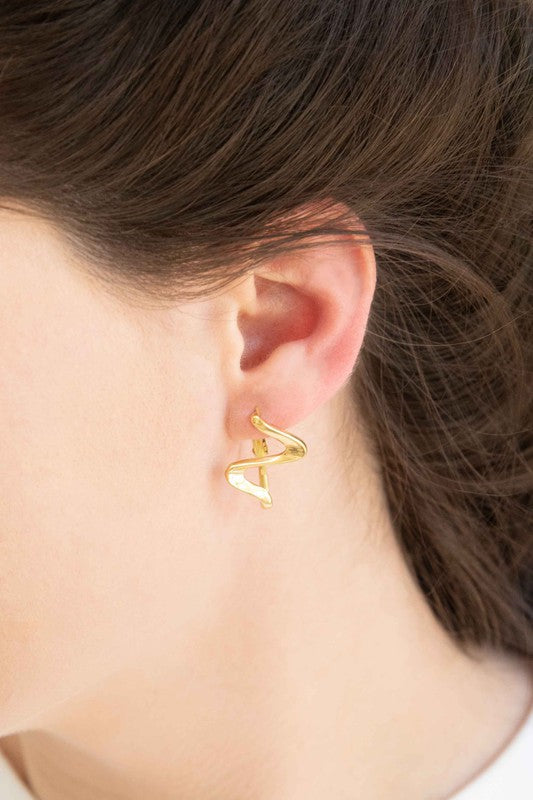 Too Wavy Hoop Earrings on a white surface.