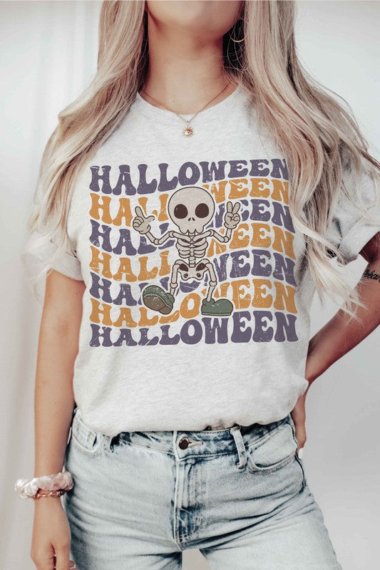 Person wearing the HALLOWEEN SKELETON Graphic Tee, which features a cartoon Halloween skeleton and the word "HALLOWEEN" repeated in orange and purple text.