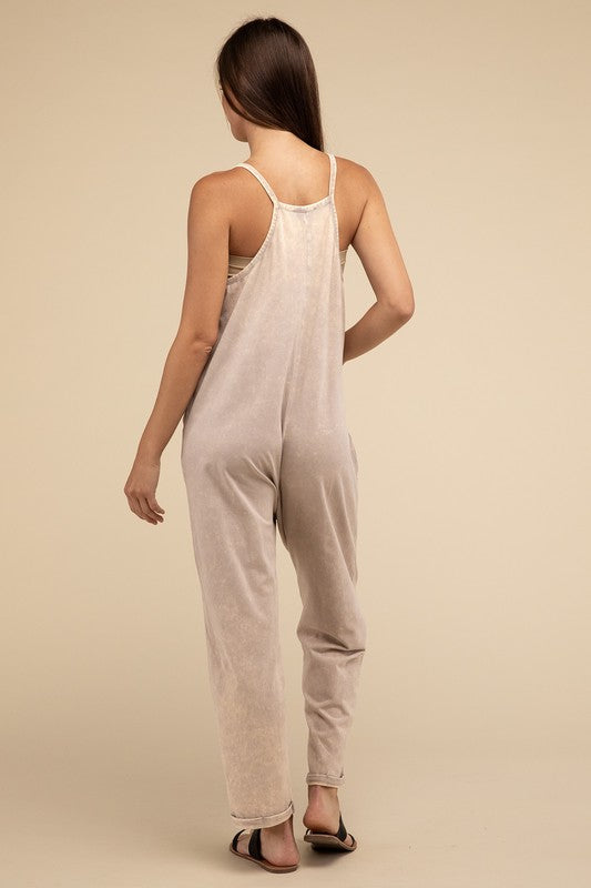 Woman standing and posing in a studio, wearing casual comfort style green Washed Spaghetti Straps Overalls with Pockets and sandals.