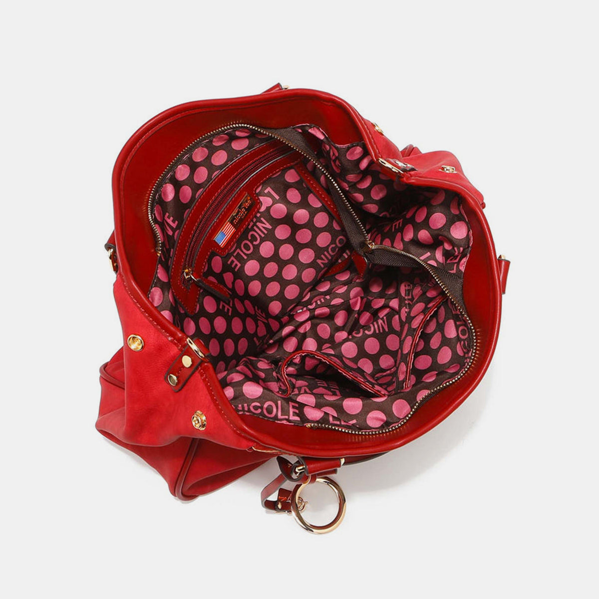 Nicole Lee USA's Scallop Stitched Tote Bag in red is made from vegan leather, showcasing textured stripes and scallop-stitched details, and includes a gold circular charm on one handle.