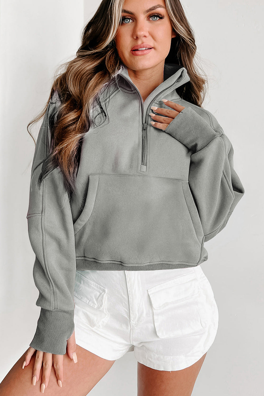 A person with long, wavy hair is seen from behind, wearing a chic Gray Fleece Lined Zip Up Stand Collar Thumbhole Sleeve Sweatshirt and white shorts, perfect for casual outings.