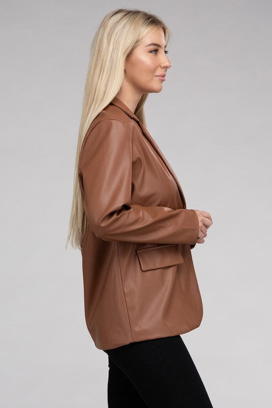 A person with long blonde hair wears the Sleek Pu Leather Blazer with Front Closure over a black top, standing against a plain background.