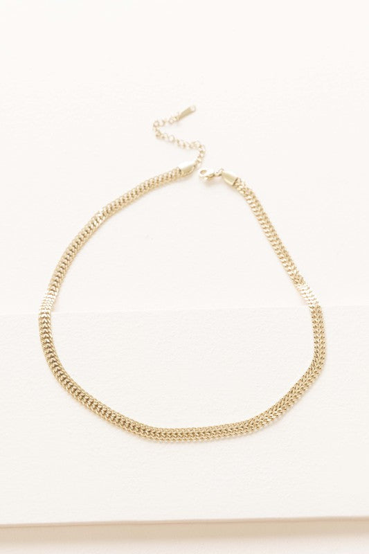 Plain gold chain necklace displayed on a white background.