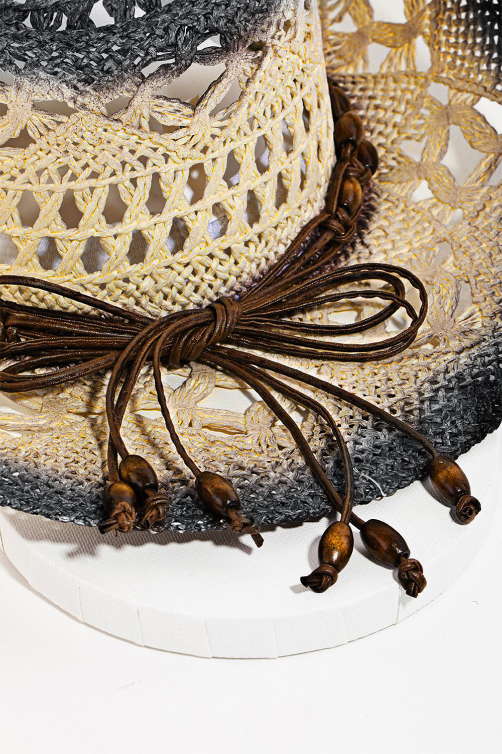 The Fame Cutout Rope Strap Wide Brim Hat is an ideal choice for summer outings, featuring a woven straw design with a dark, textured brim and a decorative band around the crown. Its stylish cutout rope strap adds an extra touch of flair.