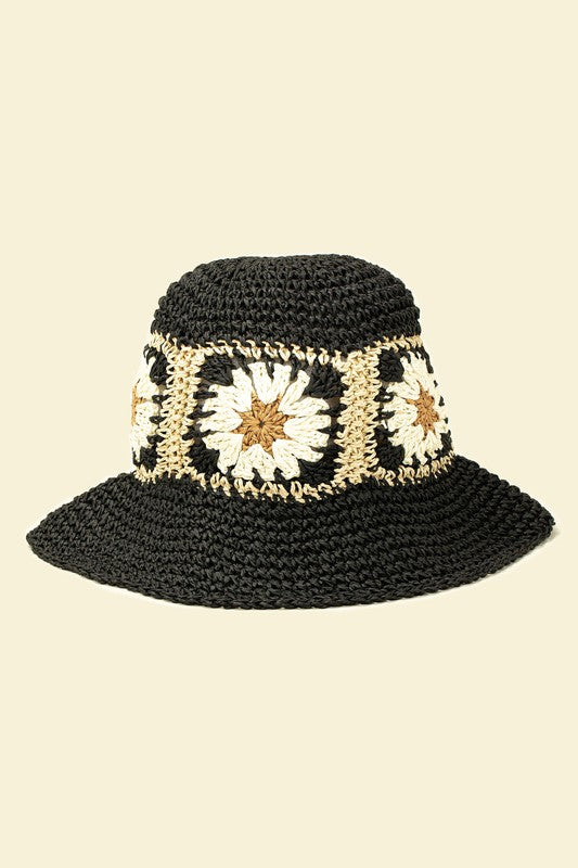 A set of four packable crochet granny square bucket hats in beige, black, and charming patterns featuring yellow flower designs, all lovingly hand-crocheted to perfection.