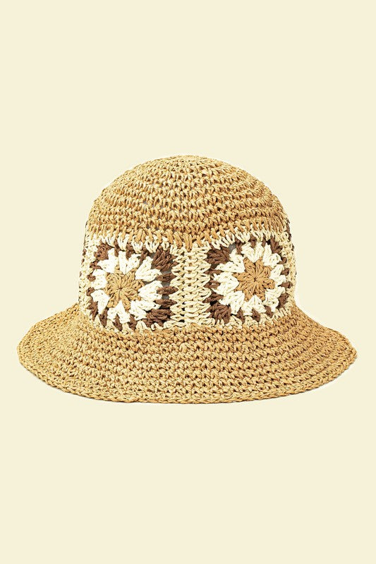 A set of four packable crochet granny square bucket hats in beige, black, and charming patterns featuring yellow flower designs, all lovingly hand-crocheted to perfection.