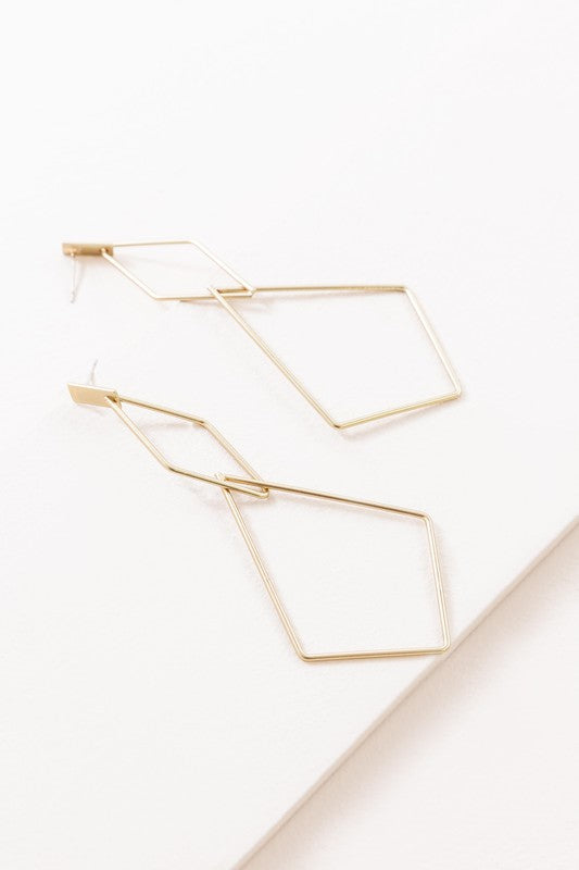 The Shape Of You Drop Earrings, featuring geometric and angular abstract designs crafted in sterling silver, are displayed against a plain white background.