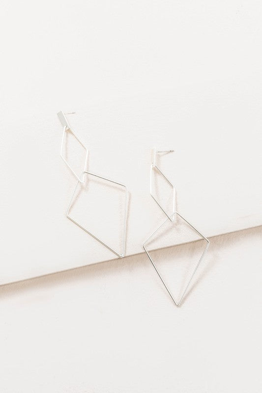 The Shape Of You Drop Earrings, featuring geometric and angular abstract designs crafted in sterling silver, are displayed against a plain white background.