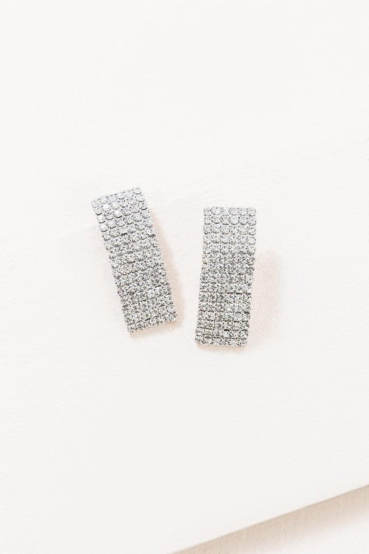 A pair of Rhinestone Curved Earrings against a white background.
