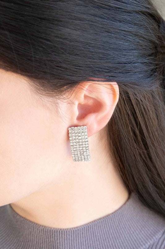 A pair of Rhinestone Curved Earrings against a white background.