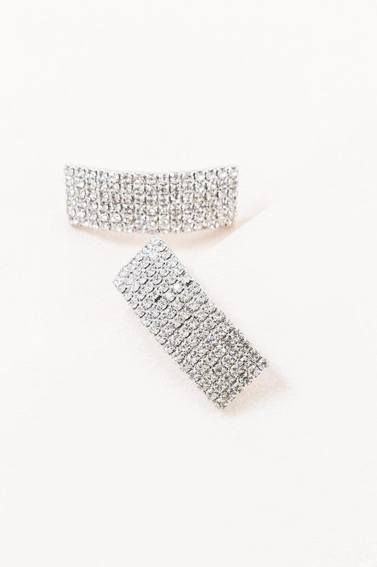 A pair of Rhinestone Curved Earrings against a white background.