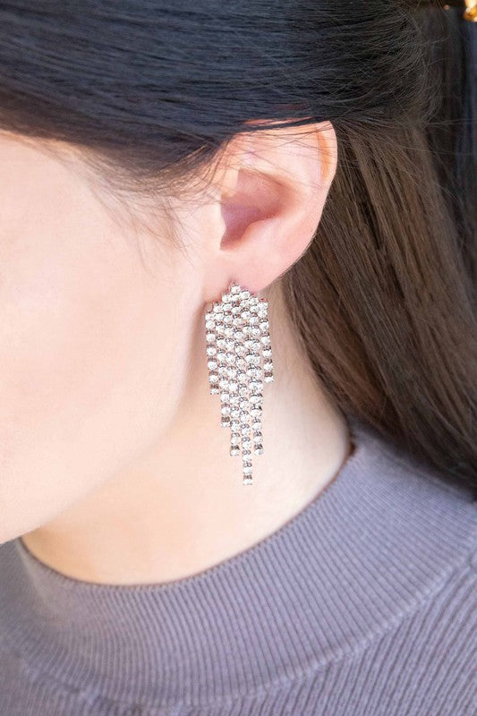 The Rhinestone Tassel Earrings exude Hollywood glam with their silver, dangling design set against a light background, featuring multiple cascading strands that epitomize formal jewelry elegance.