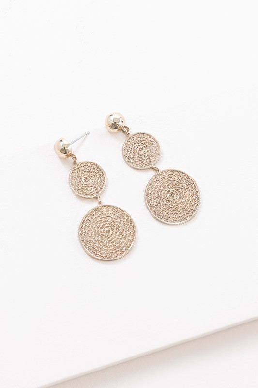 The exquisite Golden Webbed Earrings, crafted from brass with a gold-tone finish, showcase round, three-tiered drop earrings featuring an intricate webbed lattice design and are elegantly displayed on a white surface.