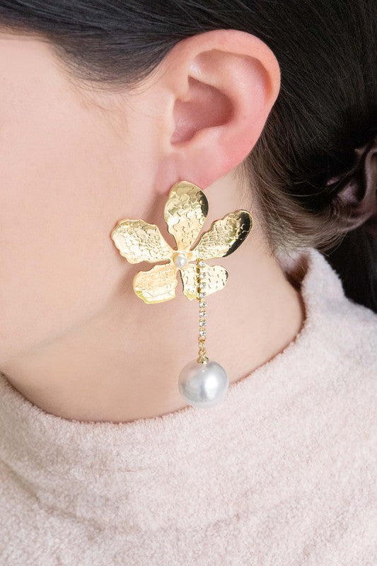Golden Flower Drop Earrings with pearl accents displayed on a white surface feature sterling silver posts.