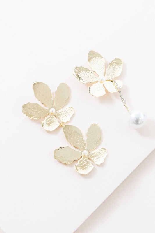 Golden Flower Drop Earrings with pearl accents displayed on a white surface feature sterling silver posts.