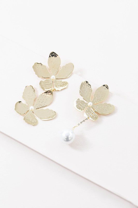 Golden Flower Drop Earrings with pearl accents displayed on a white surface feature sterling silver posts.