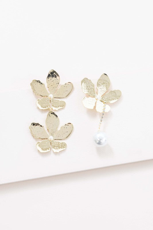Golden Flower Drop Earrings with pearl accents displayed on a white surface feature sterling silver posts.