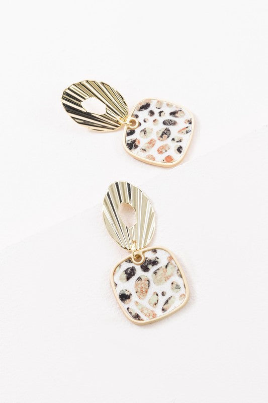 A pair of Stepping Stones Drop Earrings with patterned pendants on a white background.