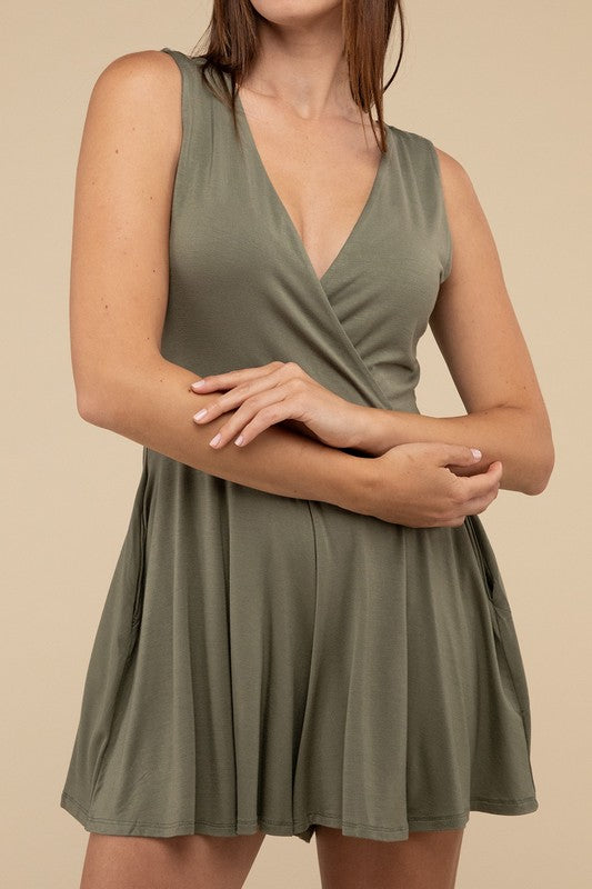 A woman stands posing in a studio, wearing a Surplice Neckline Sleeveless Romper in olive green and beige high-heeled sandals.