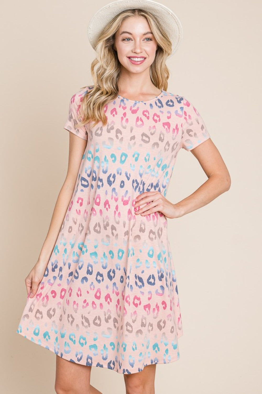 A woman wearing the BOMBOM Leopard Round Neck Short Sleeve Dress and a straw hat poses against a beige background.