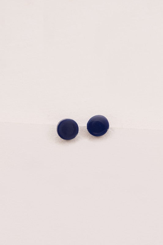 Two Porsha Circle Stud Earrings on a white surface.