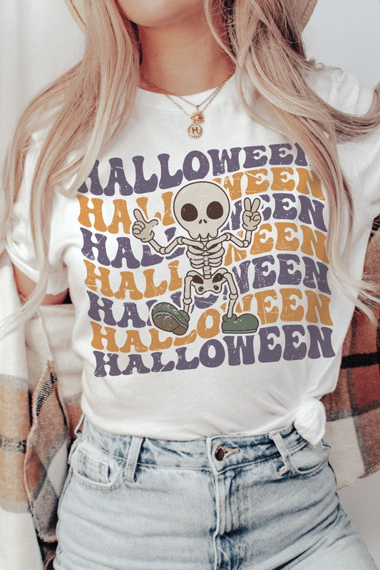 Person wearing the HALLOWEEN SKELETON Graphic Tee, which features a cartoon Halloween skeleton and the word "HALLOWEEN" repeated in orange and purple text.