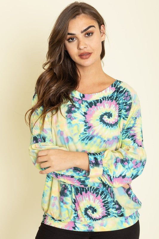 A person wearing the Boat Neck Swirl Tie Dye Tunic, featuring a vibrant spiral pattern against a plain background. Made in the United States, this eye-catching piece is both stylish and unique.