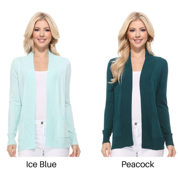 A person wearing a light yellow Open Front Shrug Sweater Knit Cardigan over a white shirt is standing against a white background.