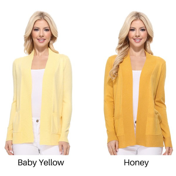 A person wearing a light yellow Open Front Shrug Sweater Knit Cardigan over a white shirt is standing against a white background.