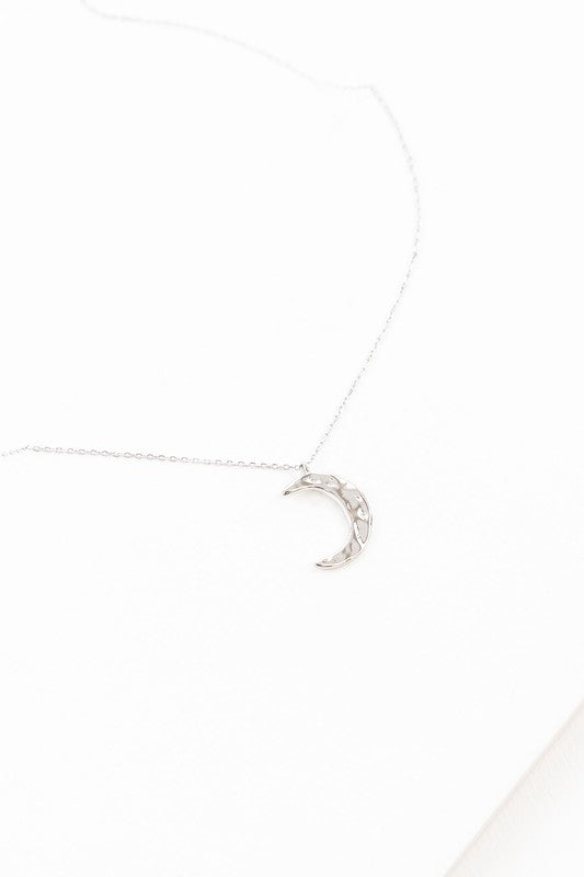 Crescent Moon Hammered Necklace on a delicate chain against a white background.