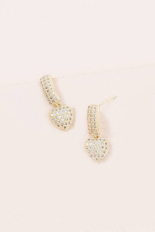 A pair of Amour Drop Earrings with pave set crystals on a light background, featuring 14k gold plating.