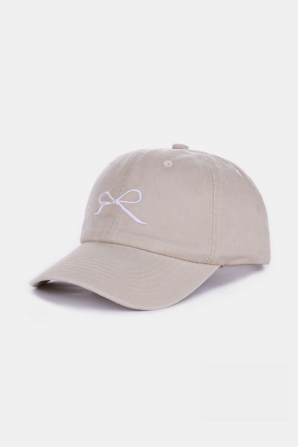 The Zenana Bow Embroidered Washed Cotton Cap features a pink design with a stylish white bow on the front, set against a plain, light background. This chic accessory seamlessly combines elegance and sportiness.