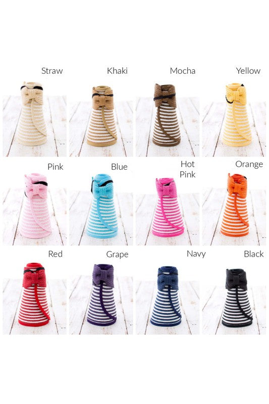 A woman from behind wearing a white bikini and a wide-brimmed, breathable Foldable Bow Stripe Visor on the beach.