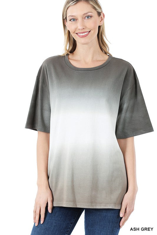 A person wearing a loose-fitting, Dip Dye Short Sleeve Round Neck Top, standing and smiling, with their hands relaxed at their sides—an ideal addition to any summer wardrobe.