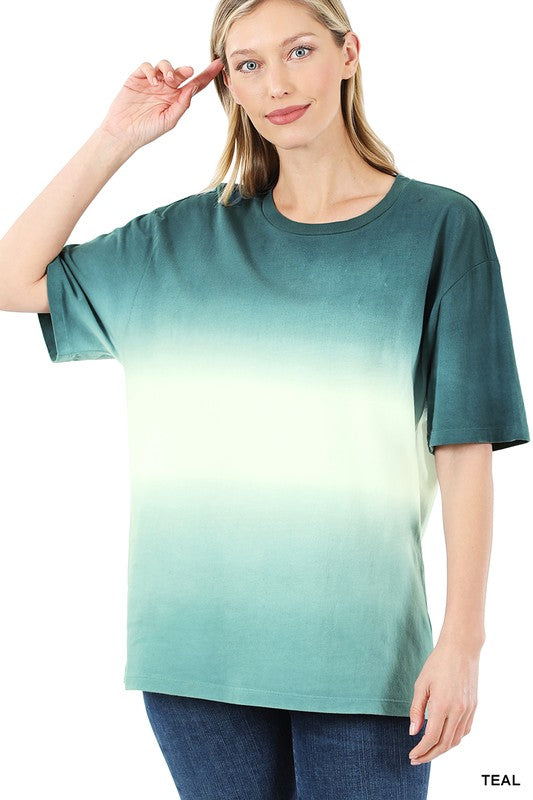 A person wearing a loose-fitting, Dip Dye Short Sleeve Round Neck Top, standing and smiling, with their hands relaxed at their sides—an ideal addition to any summer wardrobe.