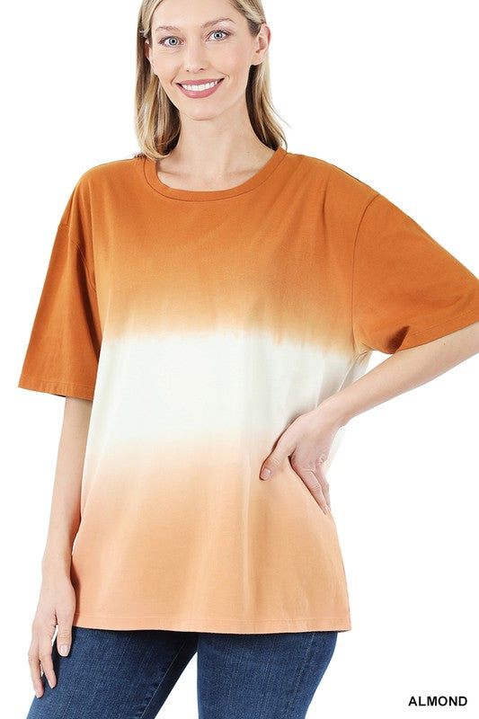 A person wearing a loose-fitting, Dip Dye Short Sleeve Round Neck Top, standing and smiling, with their hands relaxed at their sides—an ideal addition to any summer wardrobe.