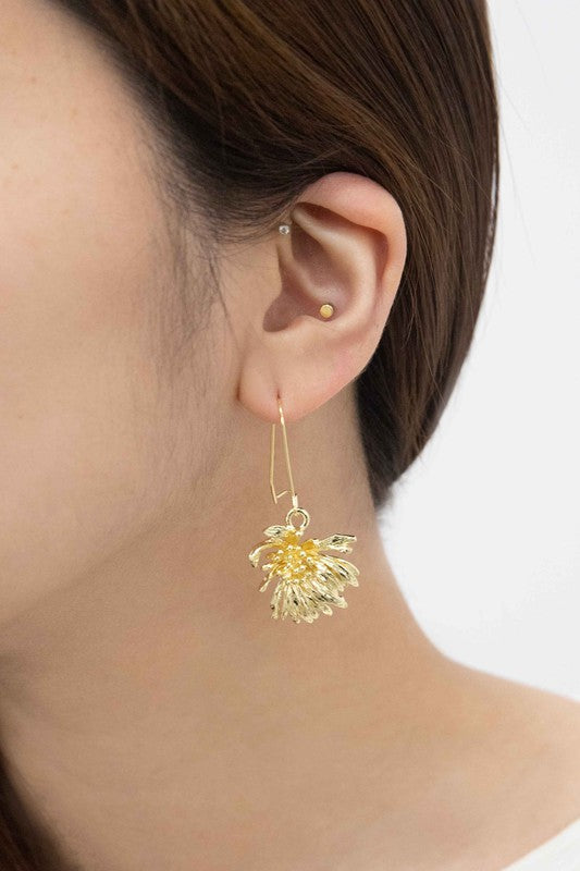 Experience the elegance of spring jewelry with the Wilted Chrysanthemum Hook Earrings, meticulously crafted and 14k gold plated, as they rest gracefully on a white surface.