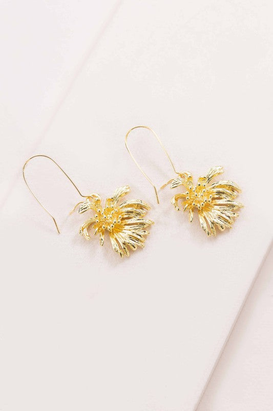 Experience the elegance of spring jewelry with the Wilted Chrysanthemum Hook Earrings, meticulously crafted and 14k gold plated, as they rest gracefully on a white surface.